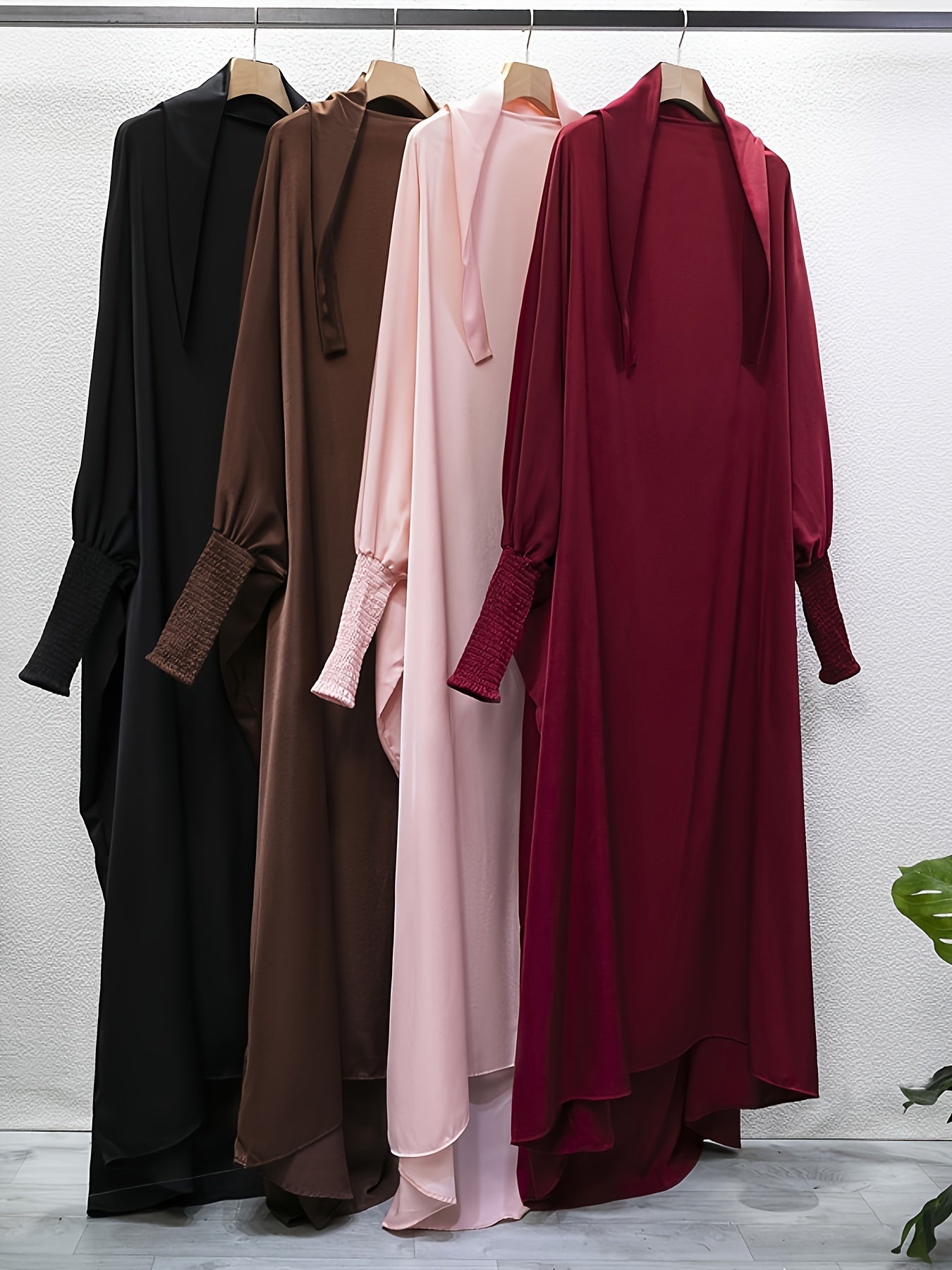 Women's One-Piece Prayer Jilbaab Dress Featuring a Hooded Design And Smocking Sleeves, Suitable for Islamic Attire, Available in Black, Inspired by Turkish Modest Fashion.