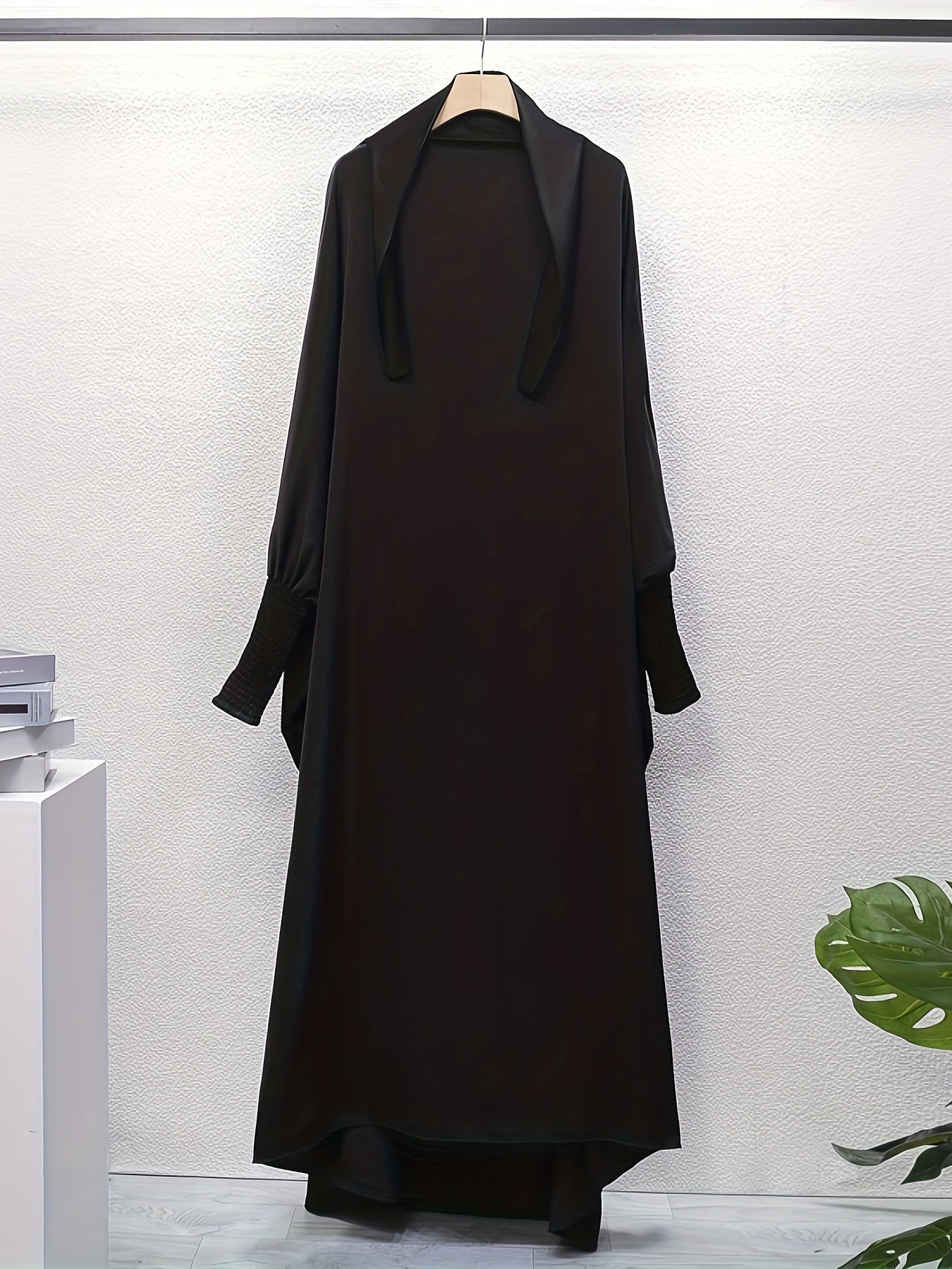 Women's One-Piece Prayer Jilbaab Dress Featuring a Hooded Design And Smocking Sleeves, Suitable for Islamic Attire, Available in Black, Inspired by Turkish Modest Fashion.