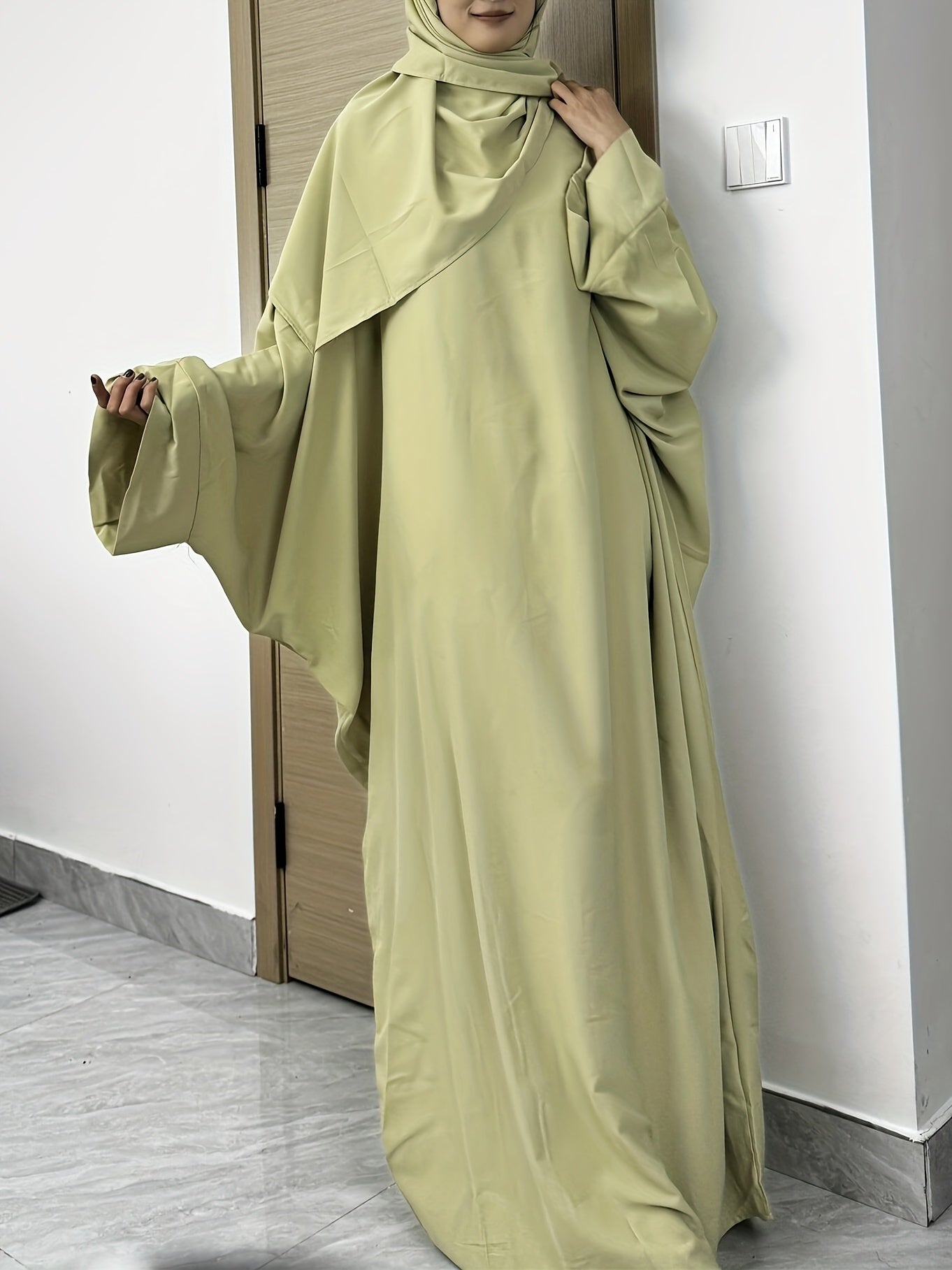 Set of 2 Muslim Jibab Abaya Dresses Featuring a Crew Neck And Batwing Sleeves, Including Hijabs, Designed for Women. These Loose-Fitting Maxi Dresses Are Suitable for Prayer And Everyday Wear.