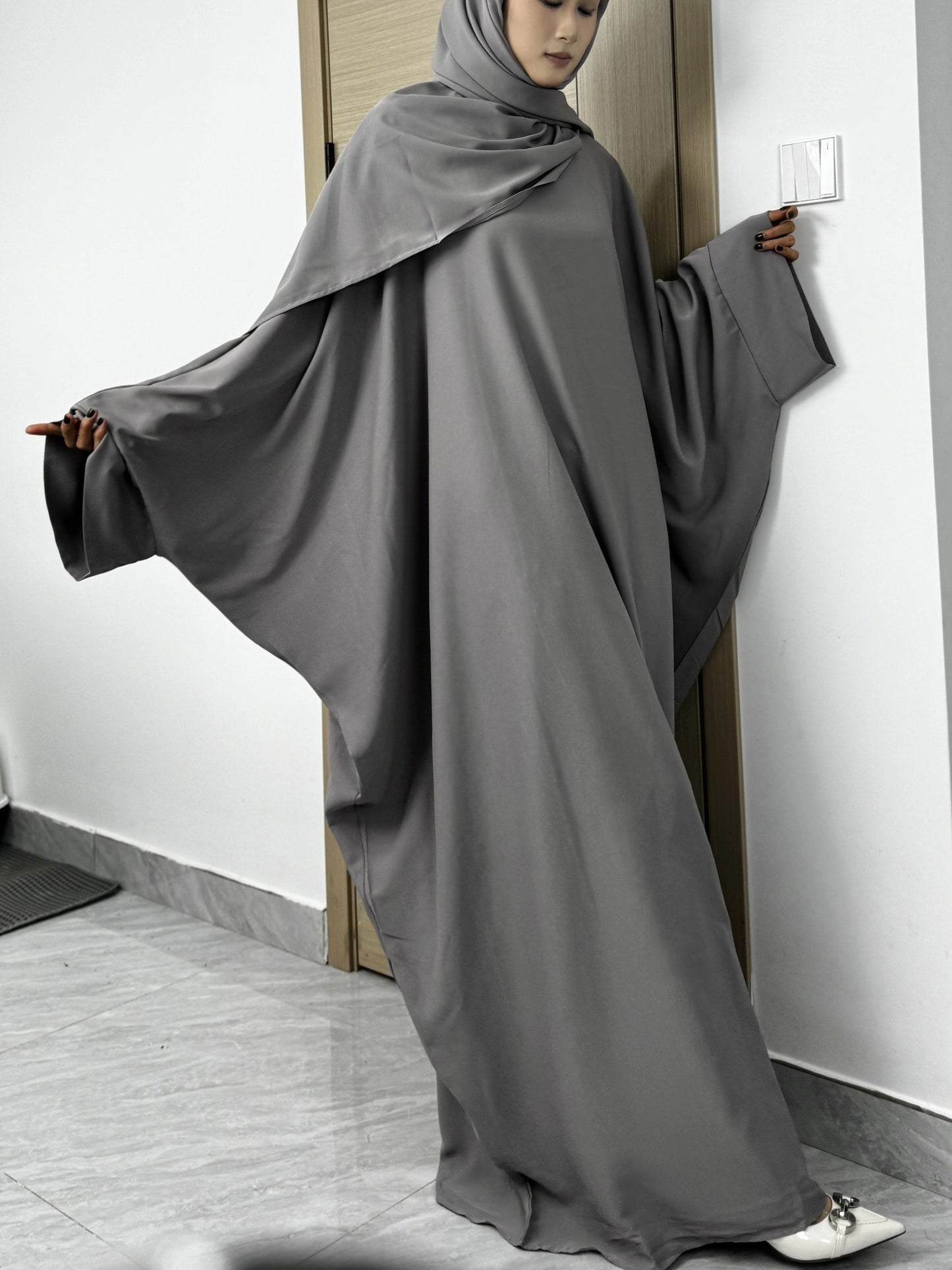 Set of 2 Muslim Jibab Abaya Dresses Featuring a Crew Neck And Batwing Sleeves, Including Hijabs, Designed for Women. These Loose-Fitting Maxi Dresses Are Suitable for Prayer And Everyday Wear.