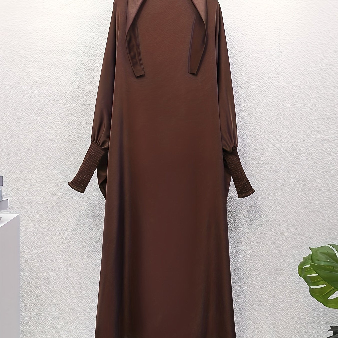Women's One-Piece Prayer Jilbaab Dress Featuring a Hooded Design And Smocking Sleeves, Suitable for Islamic Attire, Available in Black, Inspired by Turkish Modest Fashion.