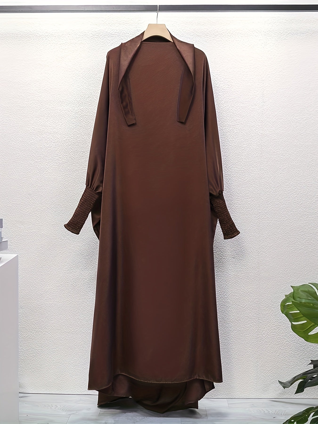 Women's One-Piece Prayer Jilbaab Dress Featuring a Hooded Design And Smocking Sleeves, Suitable for Islamic Attire, Available in Black, Inspired by Turkish Modest Fashion.