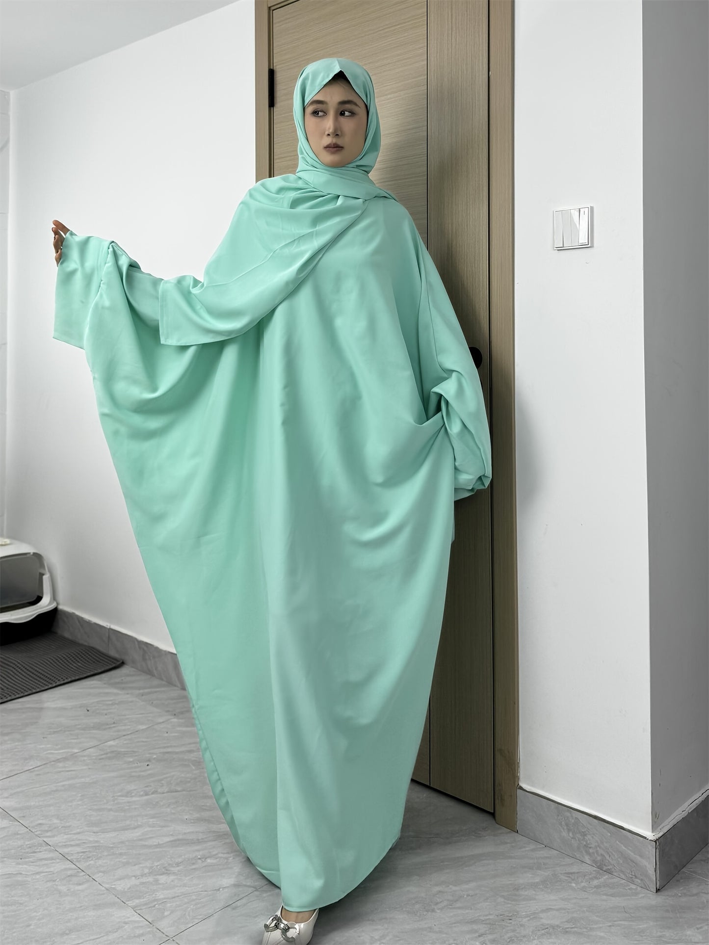Set of 2 Muslim Jibab Abaya Dresses Featuring a Crew Neck And Batwing Sleeves, Including Hijabs, Designed for Women. These Loose-Fitting Maxi Dresses Are Suitable for Prayer And Everyday Wear.