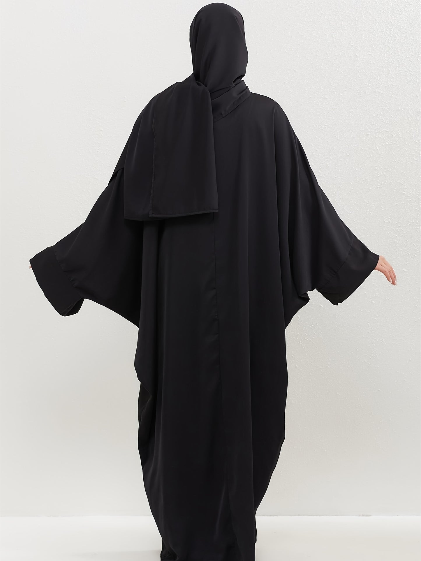 Set of 2 Muslim Jibab Abaya Dresses Featuring a Crew Neck And Batwing Sleeves, Including Hijabs, Designed for Women. These Loose-Fitting Maxi Dresses Are Suitable for Prayer And Everyday Wear.