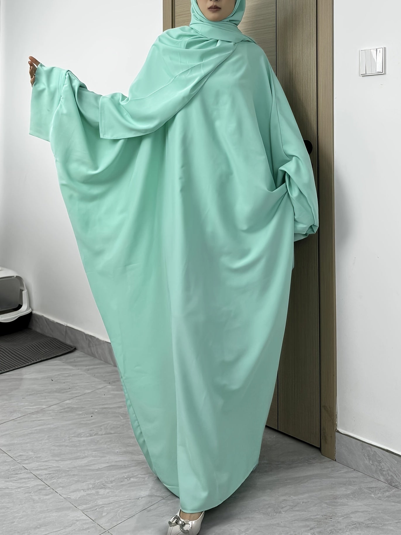 Set of 2 Muslim Jibab Abaya Dresses Featuring a Crew Neck And Batwing Sleeves, Including Hijabs, Designed for Women. These Loose-Fitting Maxi Dresses Are Suitable for Prayer And Everyday Wear.