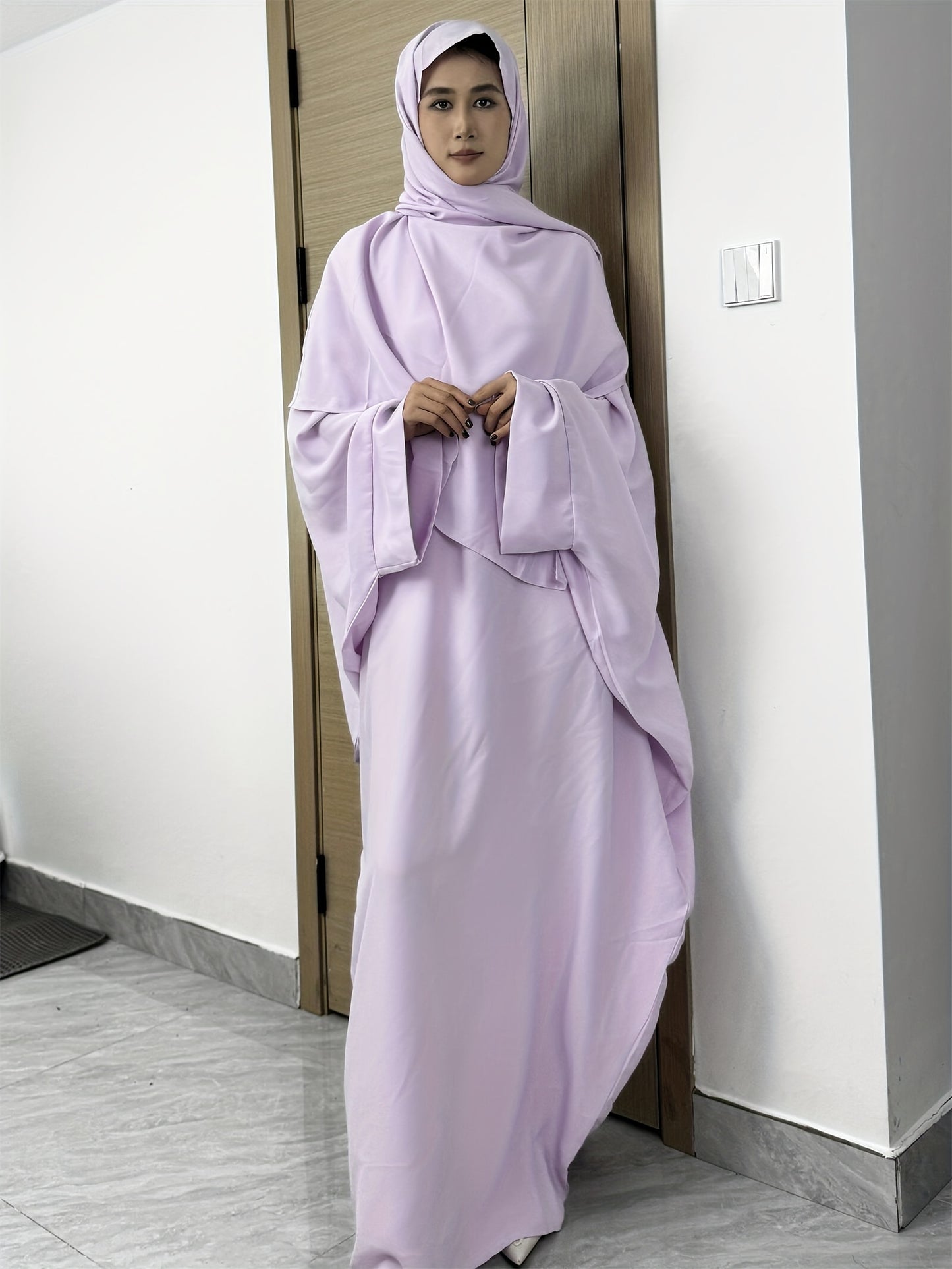 Set of 2 Muslim Jibab Abaya Dresses Featuring a Crew Neck And Batwing Sleeves, Including Hijabs, Designed for Women. These Loose-Fitting Maxi Dresses Are Suitable for Prayer And Everyday Wear.