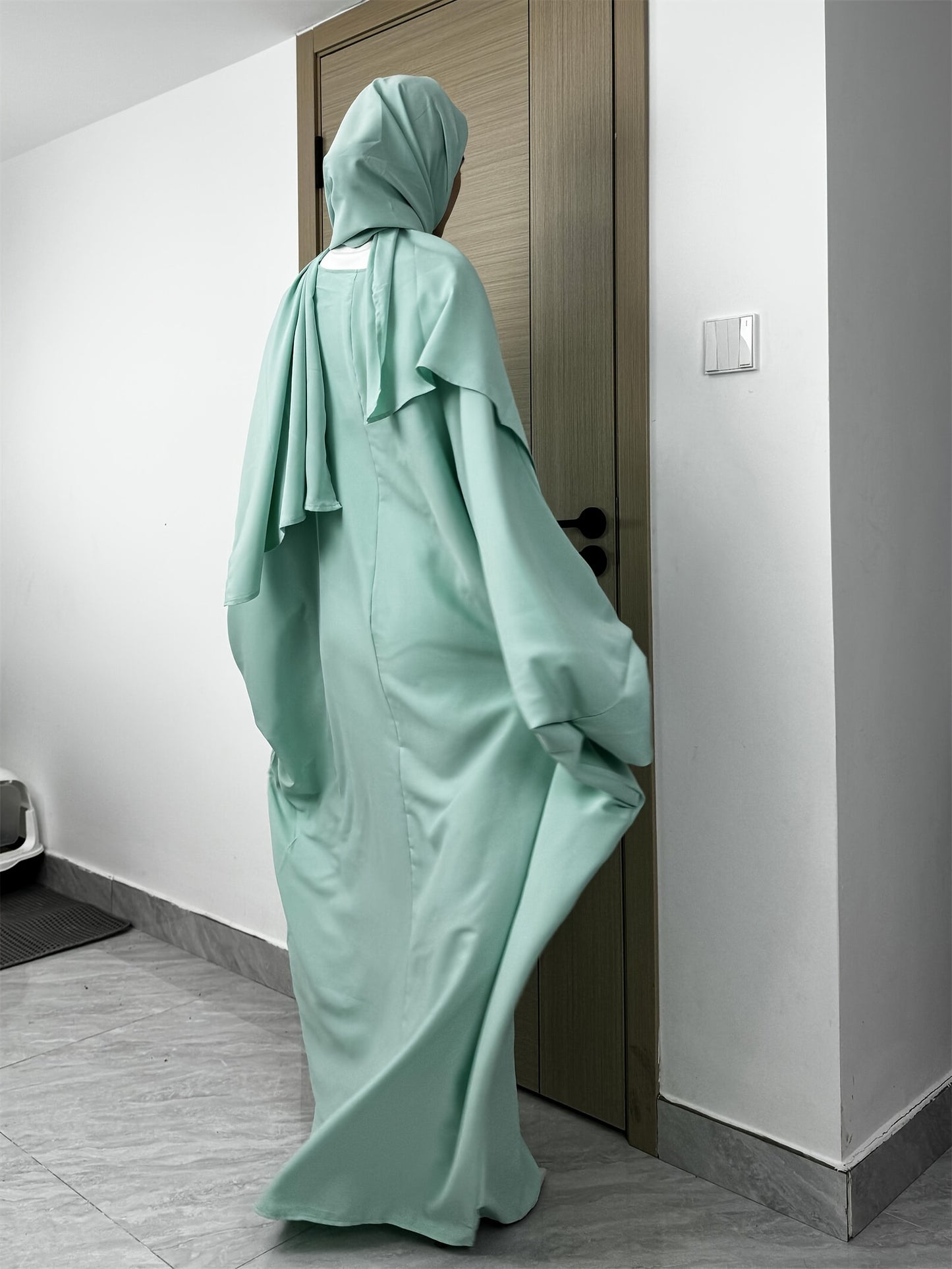 Set of 2 Muslim Jibab Abaya Dresses Featuring a Crew Neck And Batwing Sleeves, Including Hijabs, Designed for Women. These Loose-Fitting Maxi Dresses Are Suitable for Prayer And Everyday Wear.