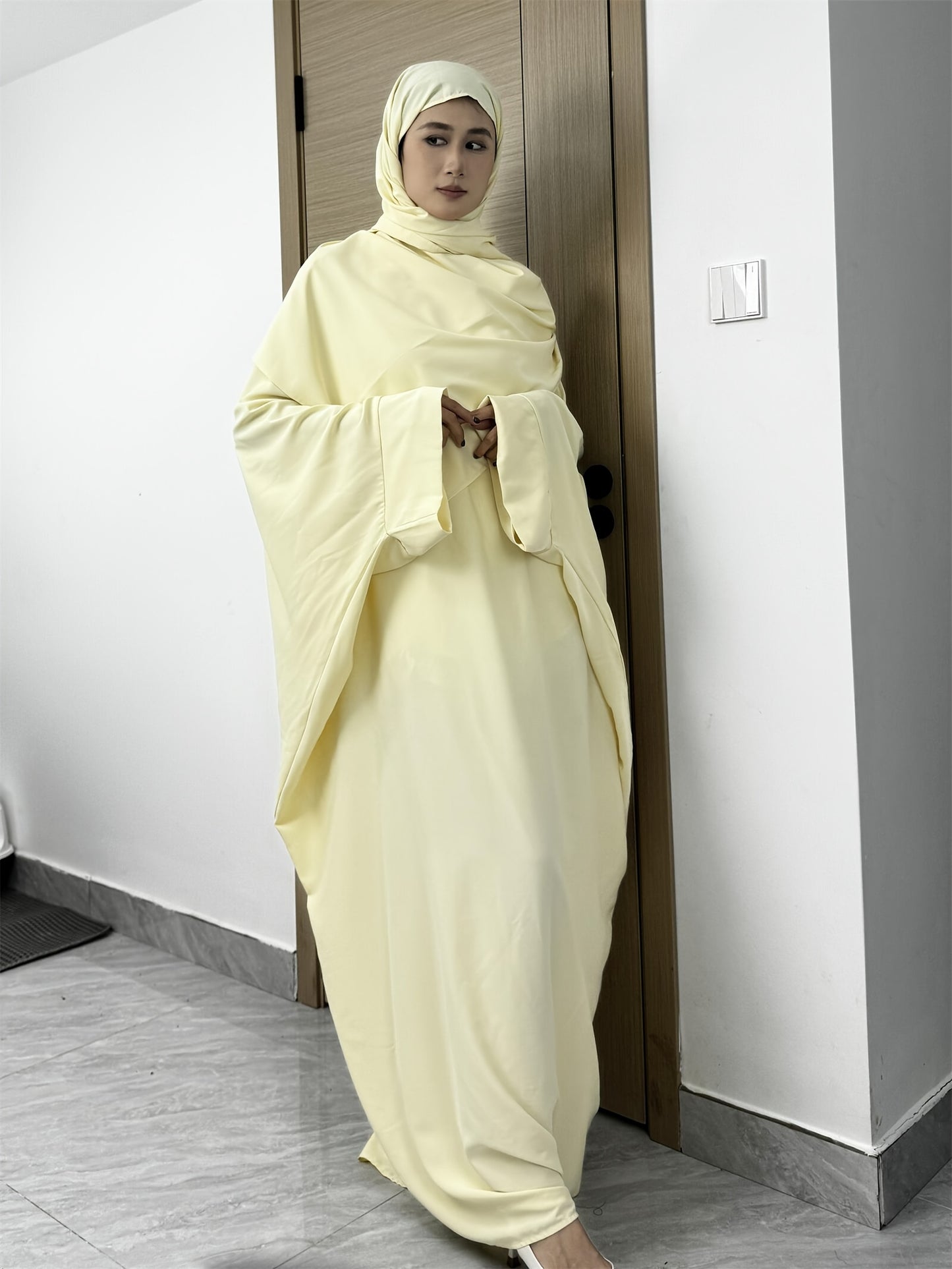 Set of 2 Muslim Jibab Abaya Dresses Featuring a Crew Neck And Batwing Sleeves, Including Hijabs, Designed for Women. These Loose-Fitting Maxi Dresses Are Suitable for Prayer And Everyday Wear.