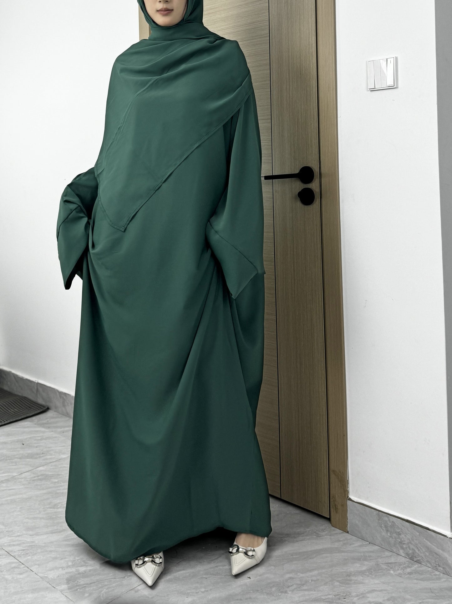 Set of 2 Muslim Jibab Abaya Dresses Featuring a Crew Neck And Batwing Sleeves, Including Hijabs, Designed for Women. These Loose-Fitting Maxi Dresses Are Suitable for Prayer And Everyday Wear.