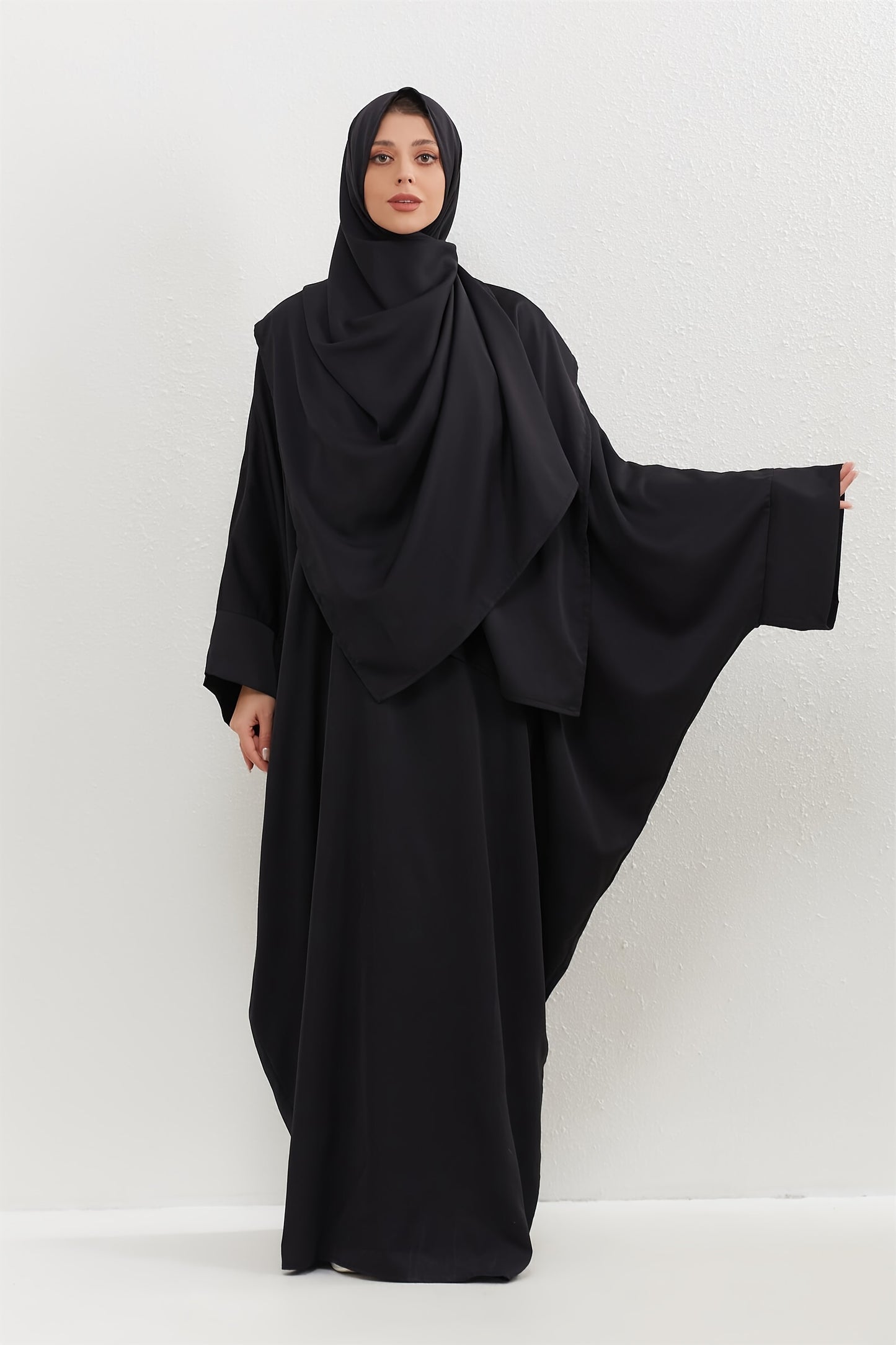 Set of 2 Muslim Jibab Abaya Dresses Featuring a Crew Neck And Batwing Sleeves, Including Hijabs, Designed for Women. These Loose-Fitting Maxi Dresses Are Suitable for Prayer And Everyday Wear.