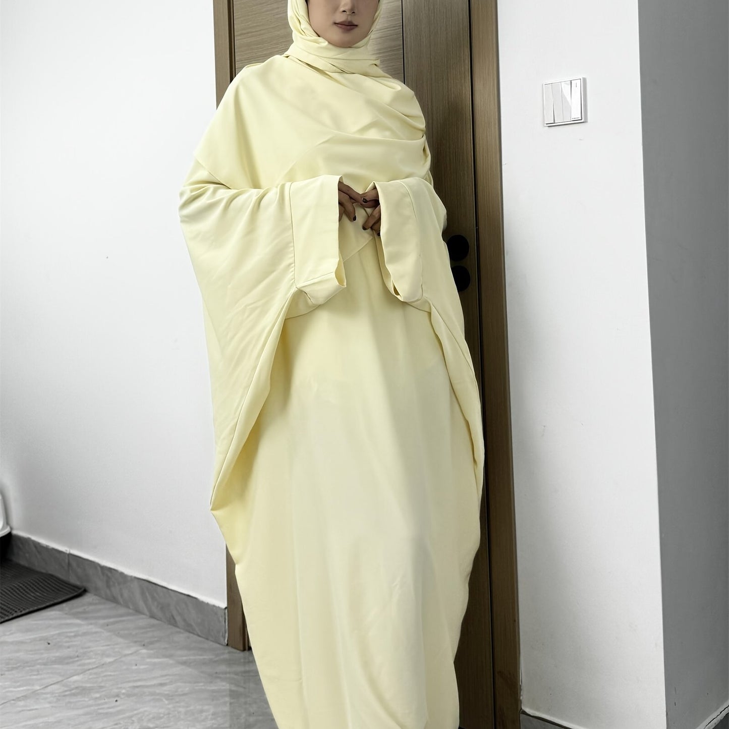 Set of 2 Muslim Jibab Abaya Dresses Featuring a Crew Neck And Batwing Sleeves, Including Hijabs, Designed for Women. These Loose-Fitting Maxi Dresses Are Suitable for Prayer And Everyday Wear.