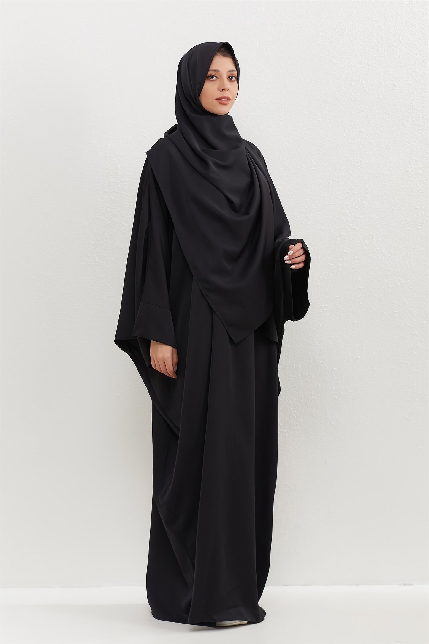 Set of 2 Muslim Jibab Abaya Dresses Featuring a Crew Neck And Batwing Sleeves, Including Hijabs, Designed for Women. These Loose-Fitting Maxi Dresses Are Suitable for Prayer And Everyday Wear.