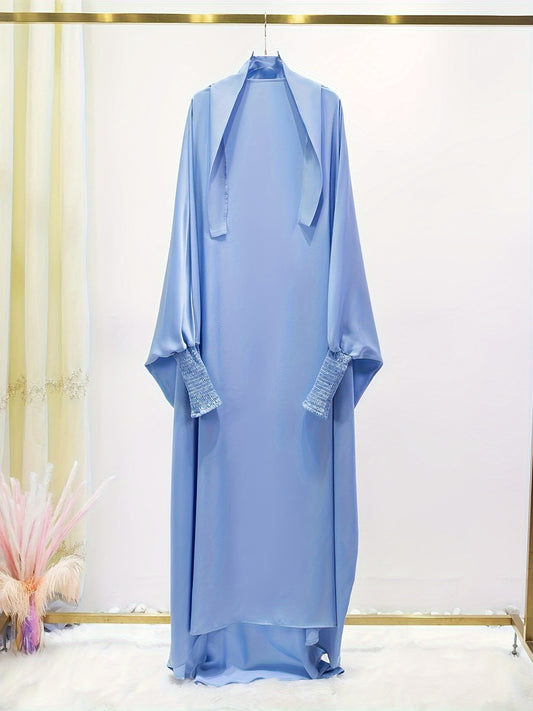 Women's One-Piece Prayer Jilbaab Dress Featuring a Hooded Design And Smocking Sleeves, Suitable for Islamic Attire, Available in Black, Inspired by Turkish Modest Fashion.